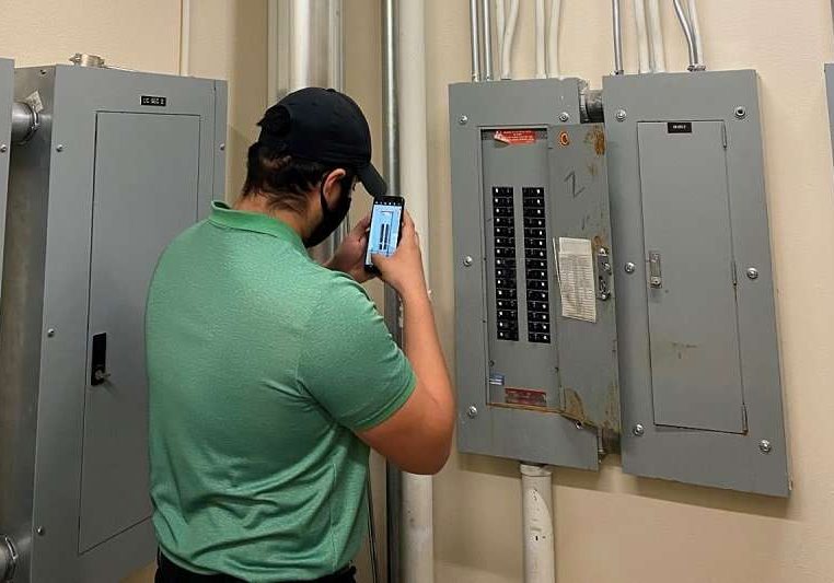 A technician working on building wellness condition assessment.